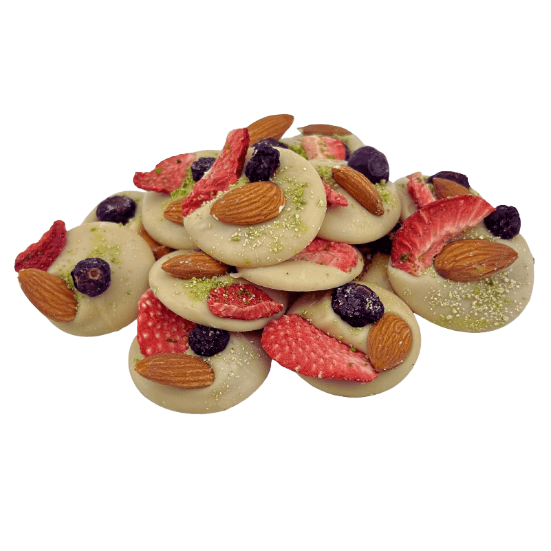 White chocolate mendiants with pistachio, almond, strawberry and blackcurrant chunks