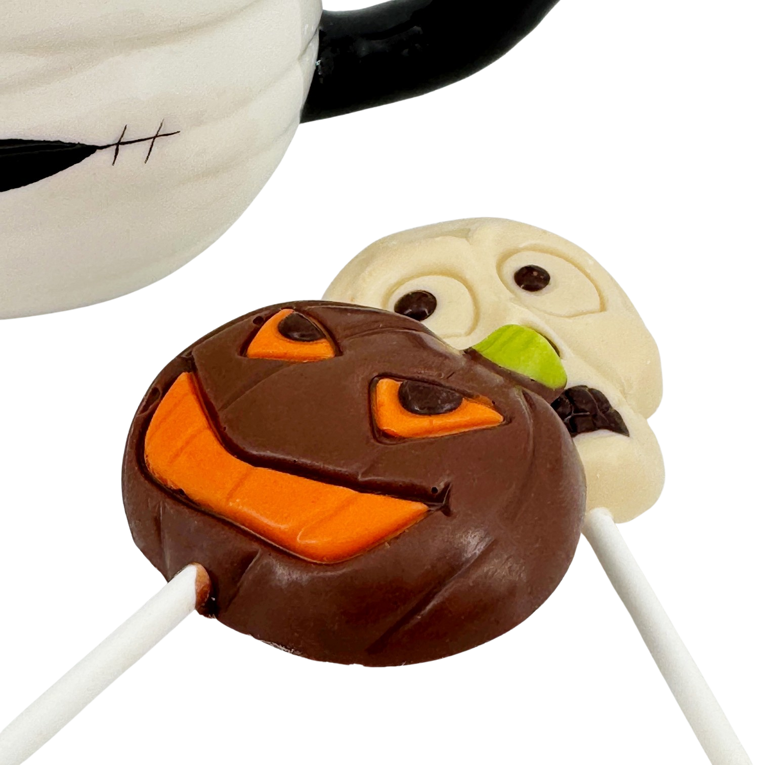 Dark chocolate drops in cup mummy with lollipops